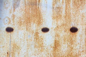 Corroded light blue metal background. Rusty metal wall. Rusty metal background with rust spots. . There are rust stains on the metal surface.