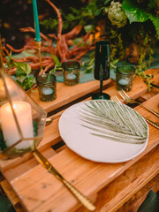 Stylish wedding table with decor, candles, dishes and floristic.