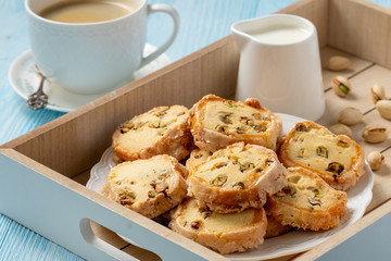 Homemade pistachio butter cookies and cup of coffee.