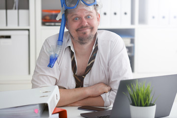 Man wearing suit and tie in goggles with snorkel
