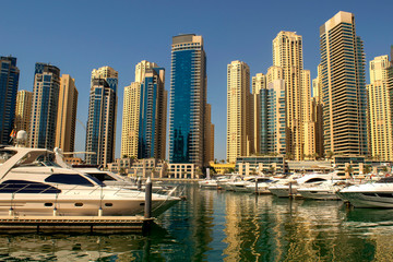 Dubai Marina district with beautiful buildings and yachts. Dubai Marina yachts parking.