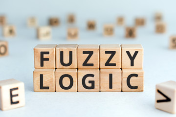 Fuzzy logic - phrase from wooden blocks with letters fuzzy logic concept, random letters around,...
