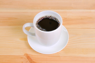 Coffee cup on wooden table background
