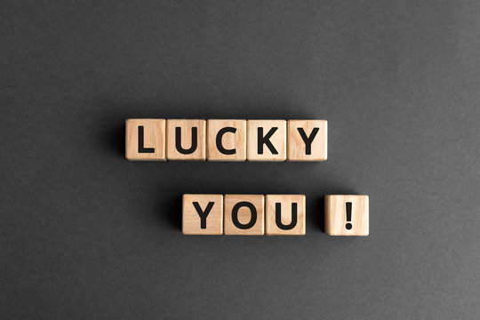 lucky you - phrase words from wooden blocks with letters, lucky you concept, top view gray background