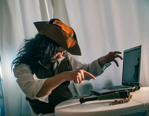 a computer pirate sitting at the laptop funny concept of digital security