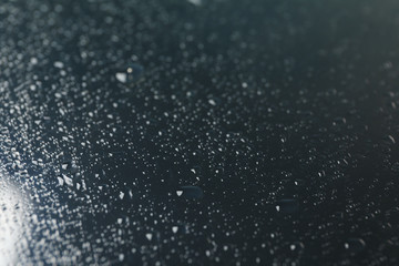 Many water drops on dark background, close up