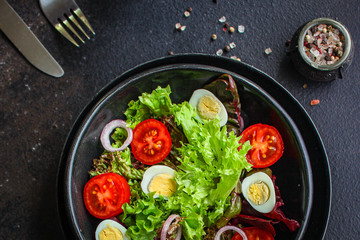 healthy salad quail eggs (vegetables, tomato, lettuce and other ingredients) menu concept. food background. top view. copy space