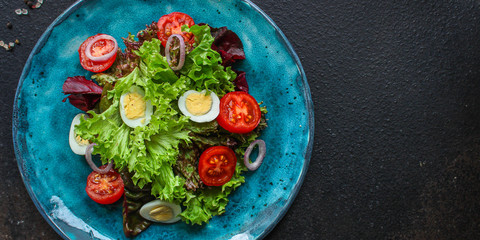 healthy salad quail eggs (vegetables, tomato, lettuce and other ingredients) menu concept. food background. top view. copy space