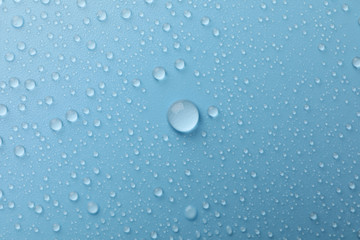 Many water drops on blue background. Texture background.