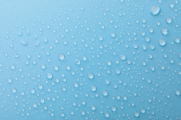 Many water drops on blue background. Texture background.