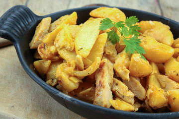 fried potatoes and chicken on a table