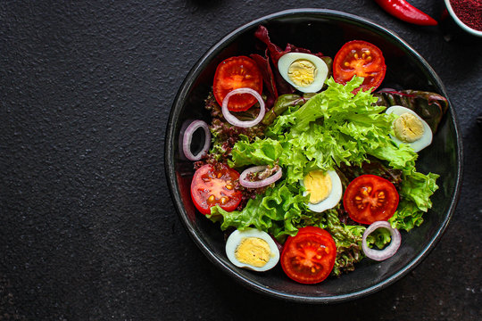 healthy salad quail eggs (vegetables, tomato, lettuce and other ingredients) menu concept. food background. top view. copy space