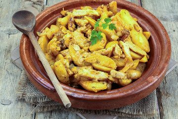 fried potatoes and chicken on a table