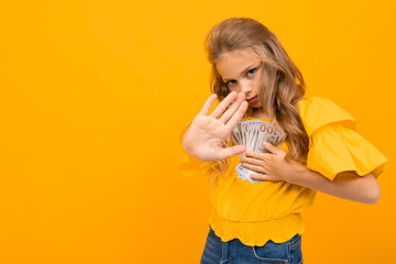 Nice little girl with a lot of money isolated on white background