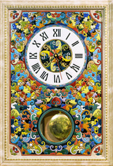 Ceramic clock with bright patterns in a wooden frame.