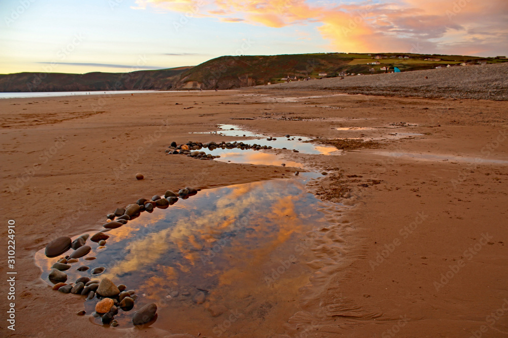 Poster sunset over newgale beach, wales