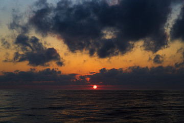 Naklejka na ściany i meble sun at sunset on the sea