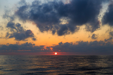 Naklejka na ściany i meble sun at sunset on the sea