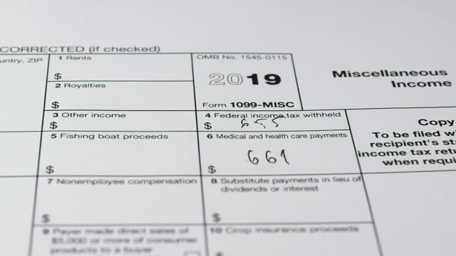 Tax reporting. Human fills out the 1099-misc tax form. Close-up