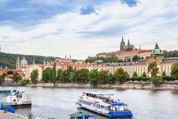 Passenger boat on the cityscape Prague background.