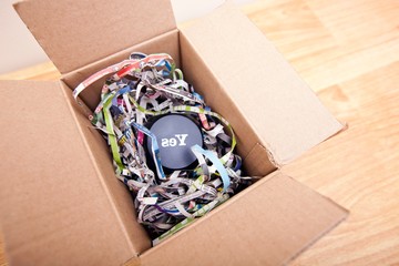 Wooden block with the word Yes wrapped in a box