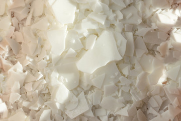 Close up of white soy wax flakes for candle making. Light texture of soy wax flakes. Ingredient for homemade candles. Ecological lifestyle - obrazy, fototapety, plakaty
