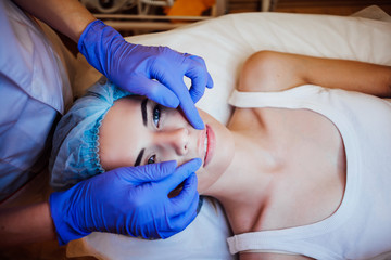 doctor cosmetologist doing facial massage girl spa