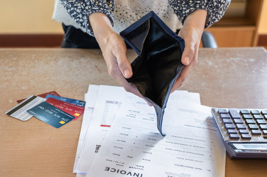 Close up of poor asian woman hand showing empty wallet as having problem bankrupt broke after credit card payday