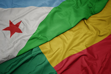 waving colorful flag of benin and national flag of djibouti.