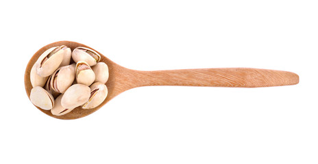 Pistachio nuts in wooden spoon on white background.