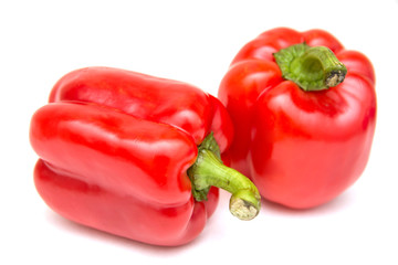 Ripe and delicious red bell peppers or paprika isolated over white background. Organic and healthy food concept. Agriculture and harvest. Vegetarian food. Supermarket banner. Selective focus.