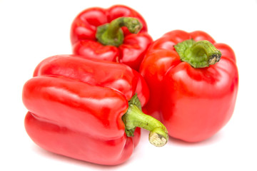Ripe and delicious red bell peppers or paprika isolated over white background. Organic and healthy food concept. Agriculture and harvest. Vegetarian food. Supermarket banner. Selective focus.