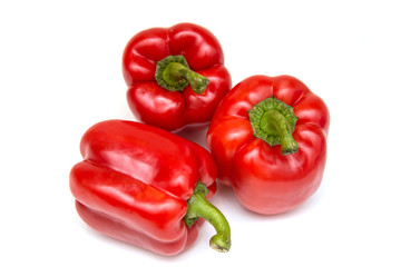 Ripe and delicious red bell peppers or paprika isolated over white background. Organic and healthy food concept. Agriculture and harvest. Vegetarian food. Supermarket banner. Selective focus.