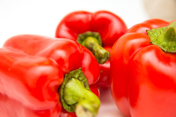 Ripe and delicious red bell peppers or paprika isolated over white background. Organic and healthy food concept. Agriculture and harvest. Vegetarian food. Supermarket banner. Selective focus.