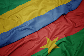 waving colorful flag of burkina faso and national flag of gabon.