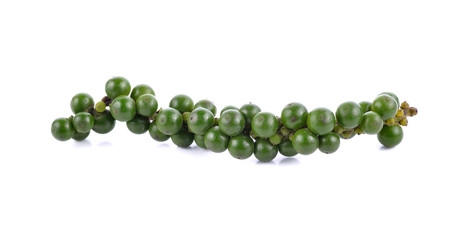 green peppercorns on white background