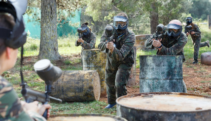 concentrated teams facing on battlefield in outdoor paintball arena © JackF