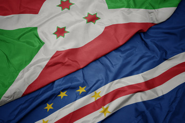 waving colorful flag of cape verde and national flag of burundi .