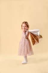 Small fashion girl . happy shopping girl runs with full bags and laughs. black Friday discount. cyber Monday. Present and gifts buy. summer sales. copy space.