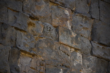 wall of a medieval church in Armenia. basalt window in a medieval church. basalt background and texture. gray texture. ancient masonry walls.