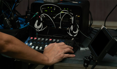 Sound engineering are using sound mixer control with hand