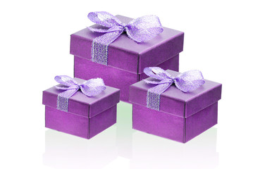 Three hot pink, purple gift boxes isolate on a white background, close-up, reflection