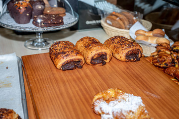 Putting bakery products on the display of a coffee shop in Madrid, Spain