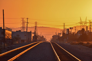 Obraz na płótnie Canvas railway tracks lit golden by sunset
