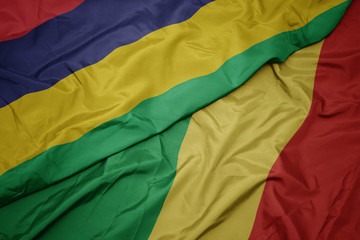 waving colorful flag of republic of the congo and national flag of mauritius.