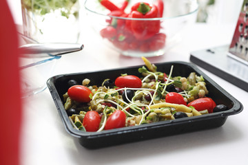 Vegetarian diet box. Salad of colorful fresh vegetables in a lunch box. Box diet. Appetizing lunch...