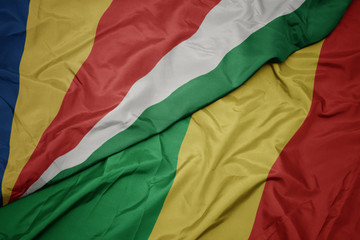 waving colorful flag of republic of the congo and national flag of seychelles.