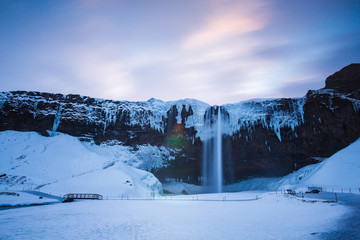 Naklejka premium Iceland seljalandsfoss waterfall, winter in Iceland, seljalandsfoss waterfall in winter