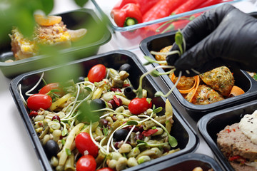 Meal prep containers, the chef prepares a meal in a boxed diet delivered to order.