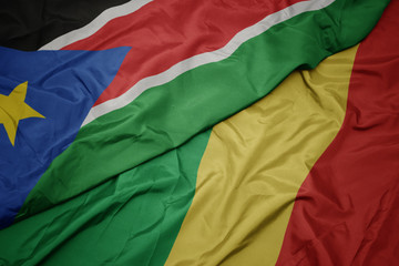waving colorful flag of republic of the congo and national flag of south sudan.